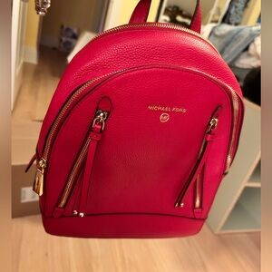 Michael Kors Red Pebbled Leather backpack purse.